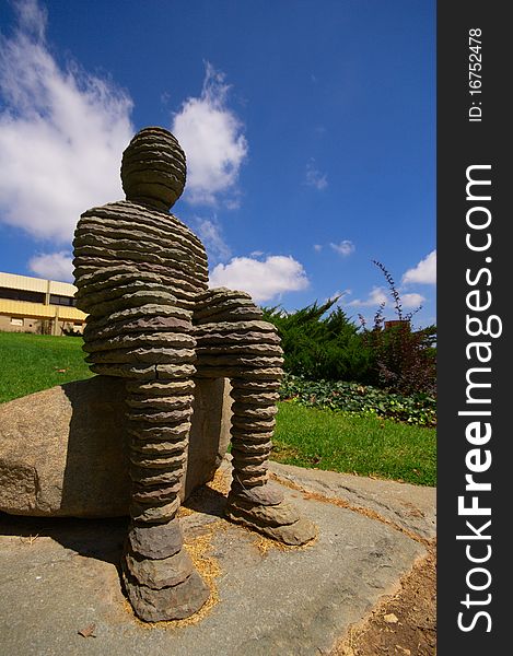 An artists sculpture of a man in a open air museum. An artists sculpture of a man in a open air museum