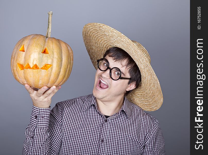 Funny men try to eat a pumpkin. Studio shot.