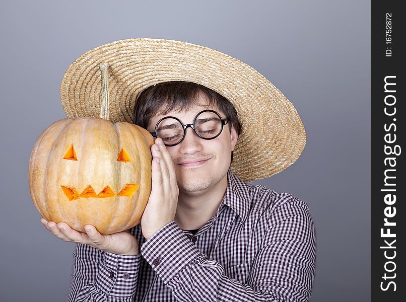 Funny men try to eat a pumpkin. Studio shot.