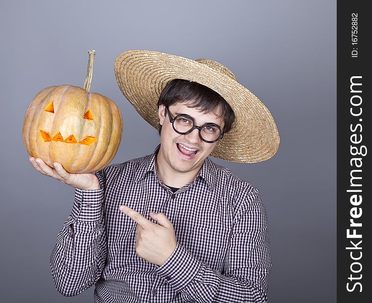 Funny men try to eat a pumpkin. Studio shot.