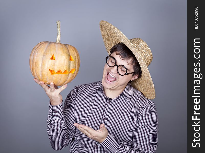 Funny men try to eat a pumpkin. Studio shot.