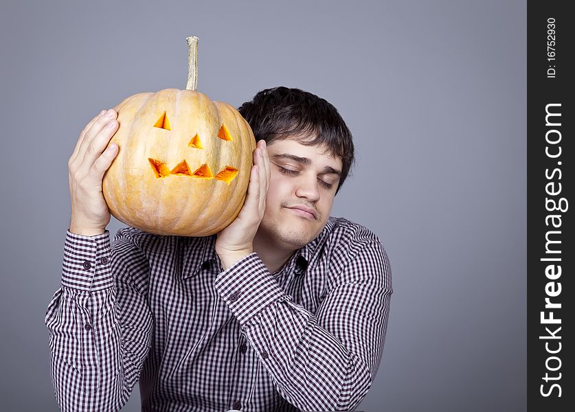 Funny men showing a pumpkin. Studio shot.