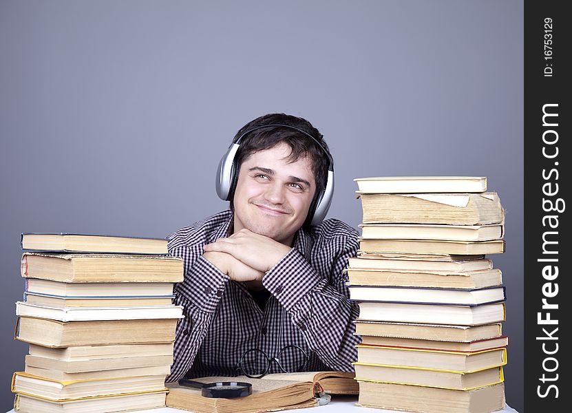 Student With The Books And Headphone Isolated.