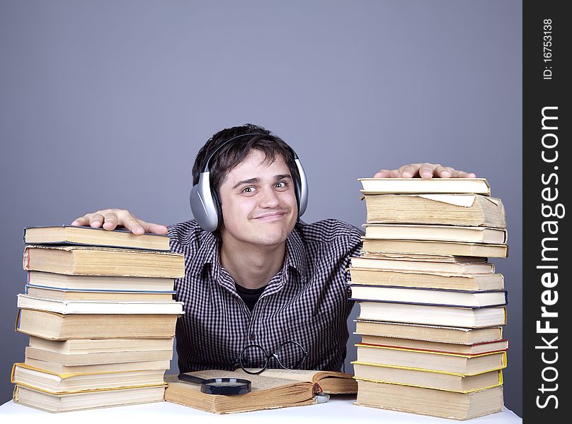 Student With The Books And Headphone Isolated.