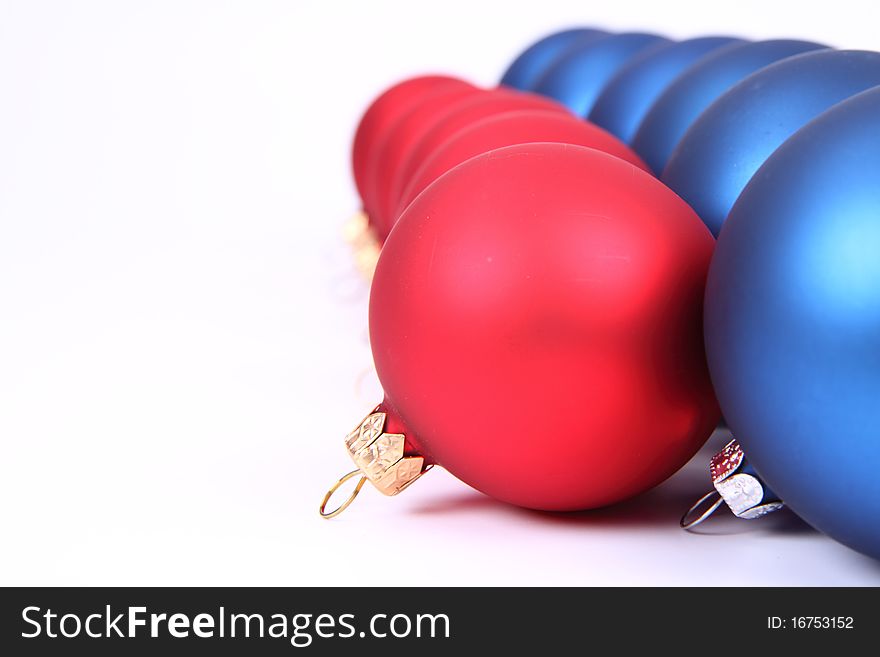 Blue and red matt christmas balls on white background, with space for your text. Blue and red matt christmas balls on white background, with space for your text