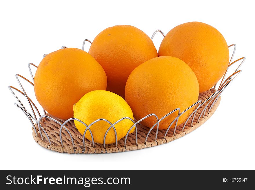 Oranges and a lemon in a fruits basket