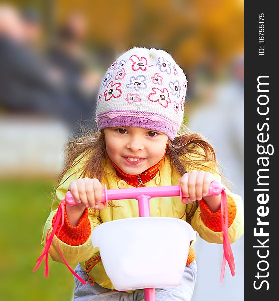 Little girl and her pink scooter