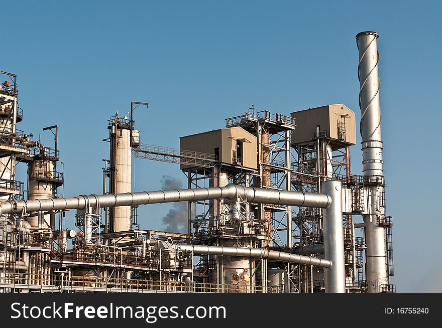 A petrochemical refinery plant with cooling towers and pipes.