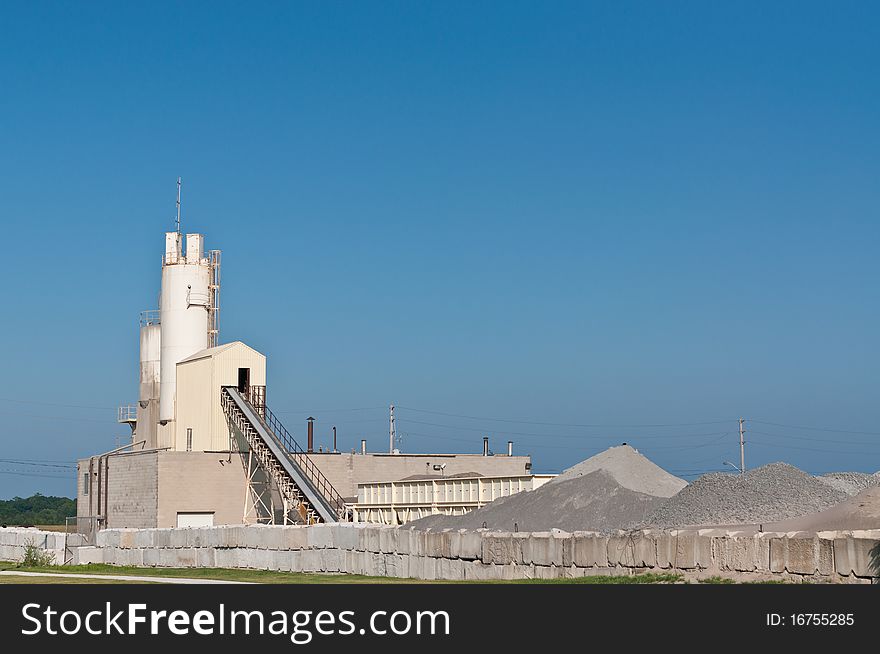 A concrete manufacturing plant with blue sky. A concrete manufacturing plant with blue sky.