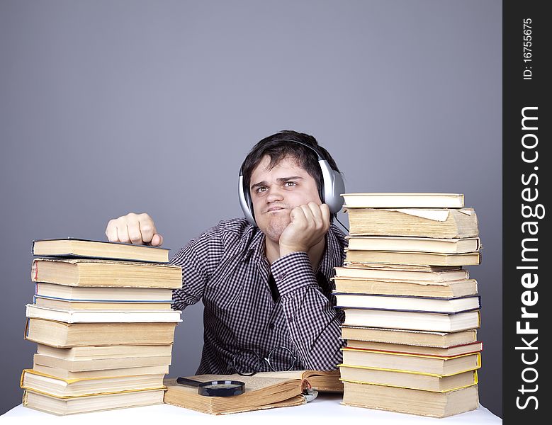 Student With The Books And Headphone Isolated.