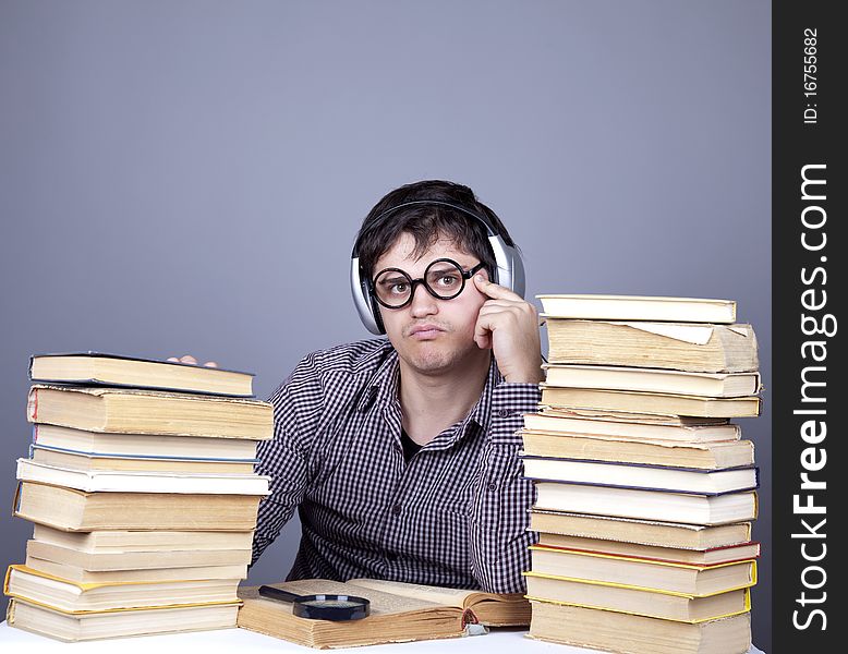 Student With The Books And Headphone Isolated.