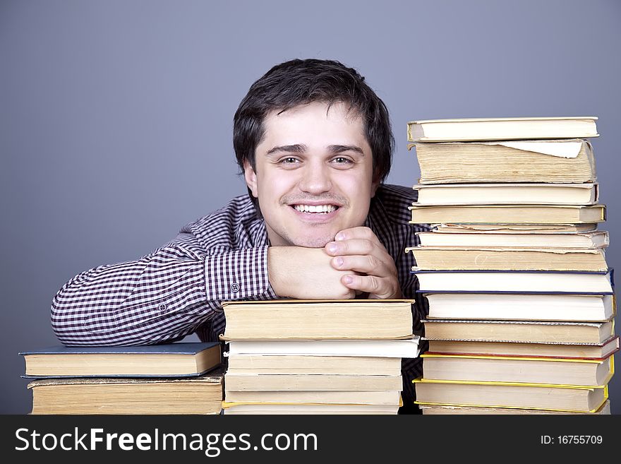 The young smiling student with the books isolated.