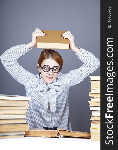 The young teacher in glasses with books. Studio shot.