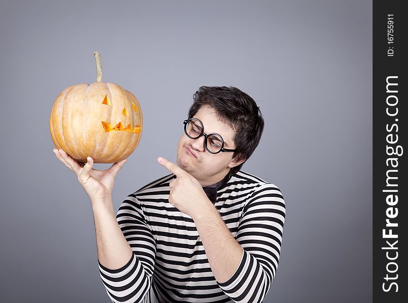 Funny mad men kepping pumpkin. Studio shot.