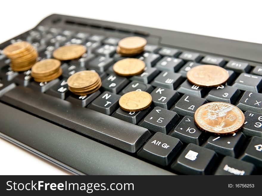 Heap of yellow coins on black keyboard. Heap of yellow coins on black keyboard