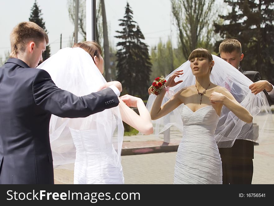 Bride and groom by the mirror outdoor