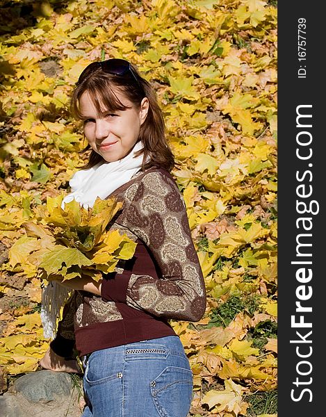 The beautiful girl with autumn leaves outdoor