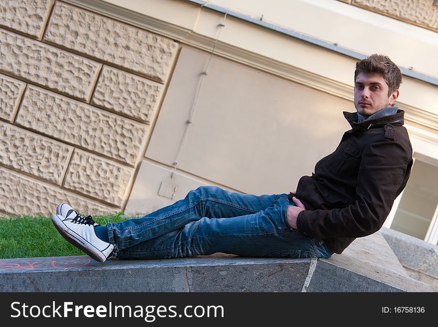 Young Man Sitting On Slope Steps