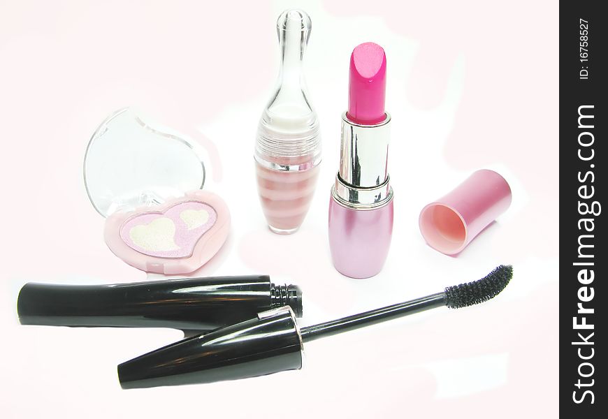 Pink lipstick eye shadows and black mascara cosmetic set. Pink lipstick eye shadows and black mascara cosmetic set