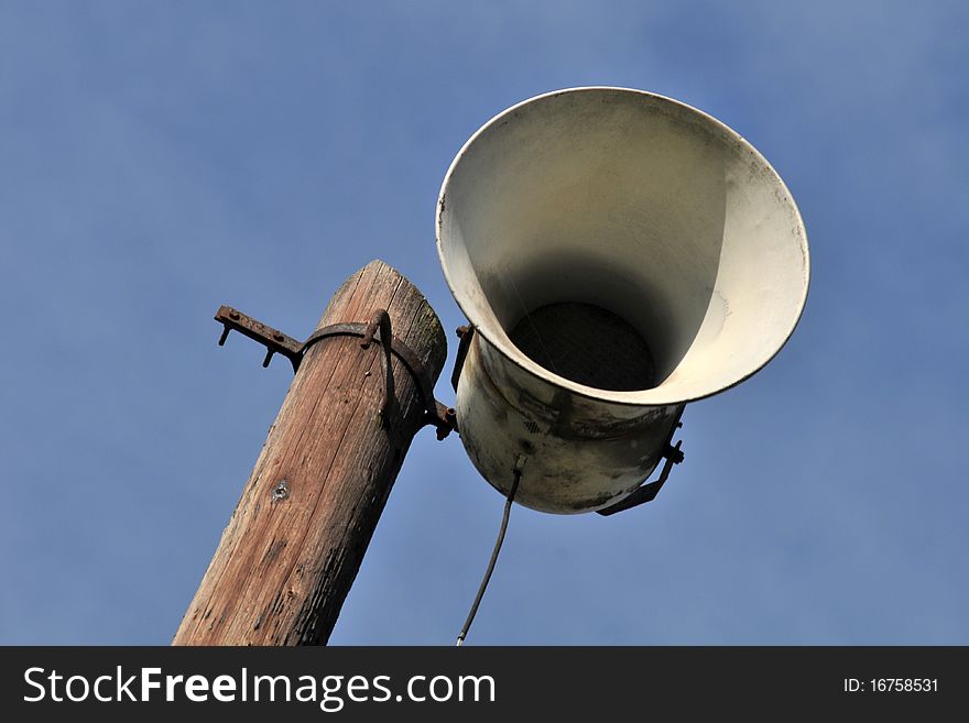 Old loudspeaker with blue sky background