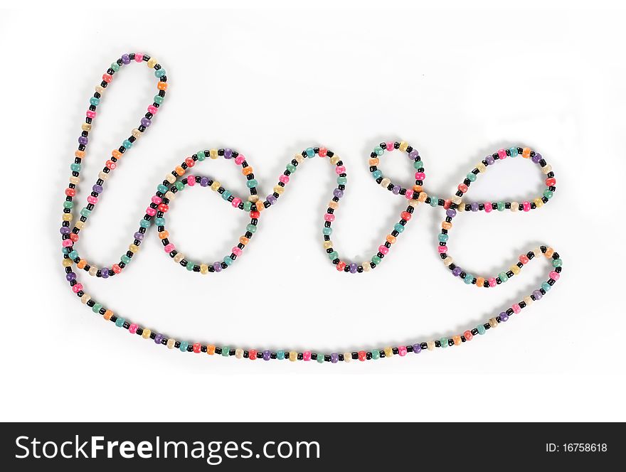 Love writing symbol made of colorful necklace. Love writing symbol made of colorful necklace