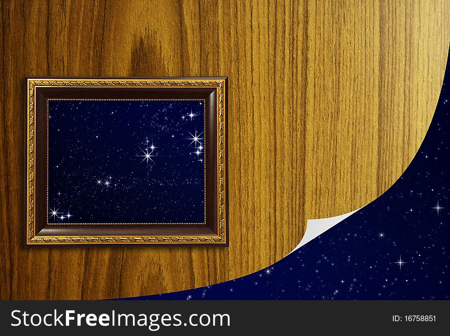 A photo of a wooden picture frame with the night sky setting inside