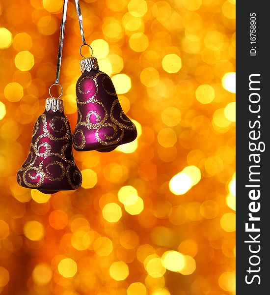 Christmas bells against gold blurred background