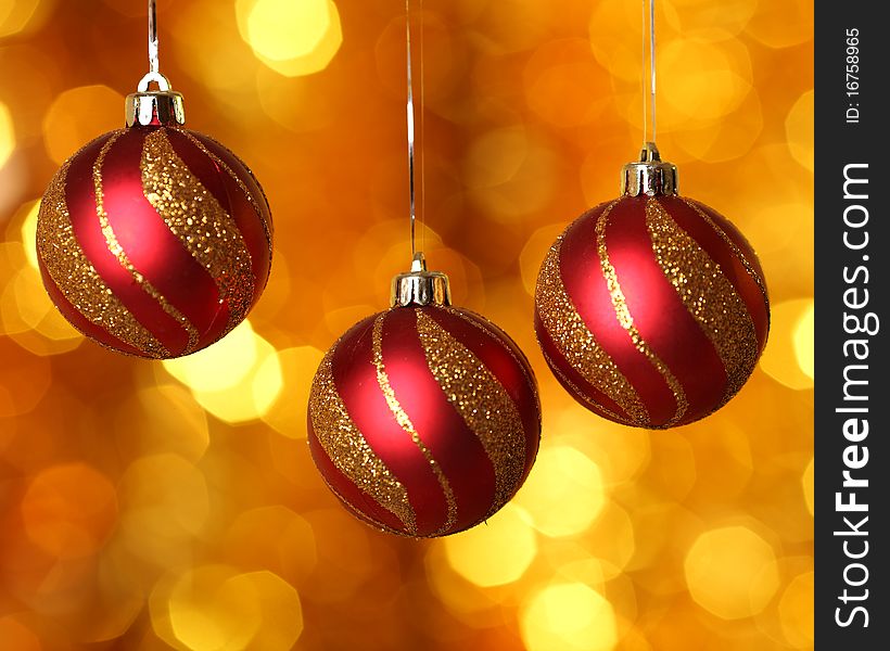 Red Christmas balls against gold background