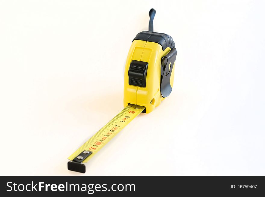 Yellow plastic tape measure on a white background close-up