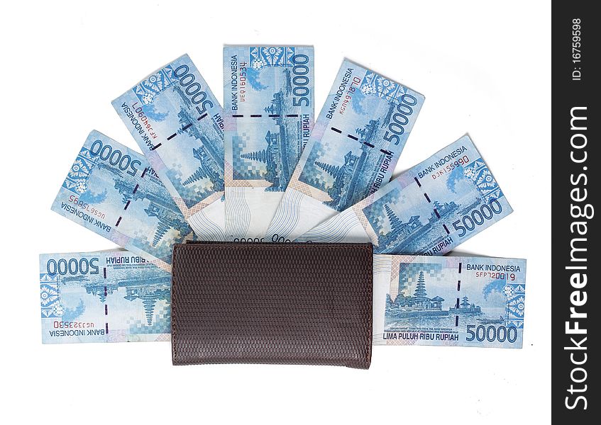 Still life photo of wallet and money over white background