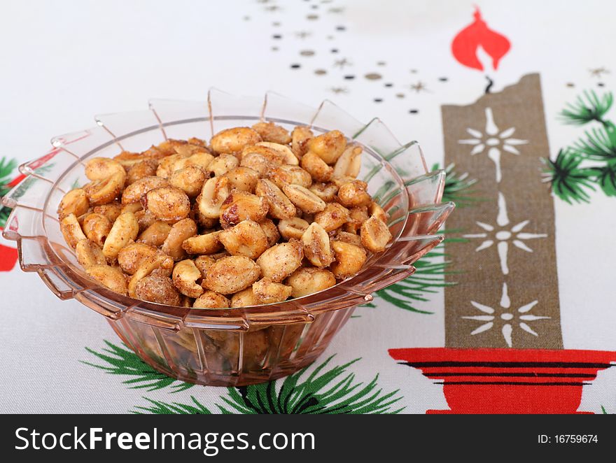 Roasted peanuts in a bowl on a Christmas tablecloth. Roasted peanuts in a bowl on a Christmas tablecloth