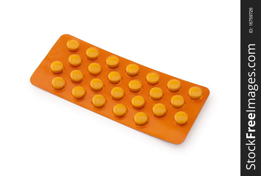 Orange medicine pills in a blister pack on a white background