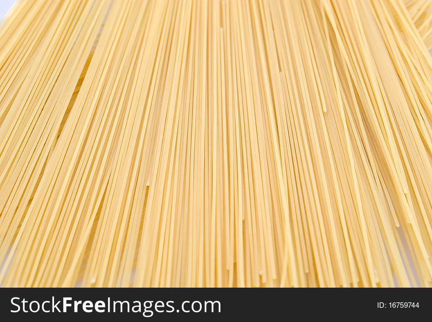 Noodless (spaghetti, pasta) made from wheat flour on a white background