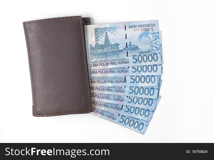 Still life photo of wallet and money over white background