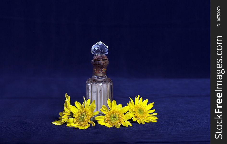 Yellow Flowers And A Vintage Perfume Bottle