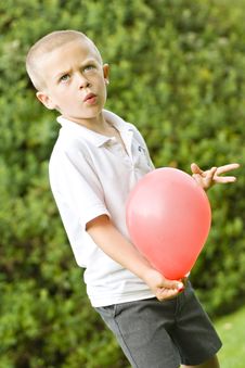 Six Year Old Boy Holding A Balloon Royalty Free Stock Image