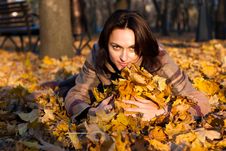 Beautiful Young Woman Lying In Autumn Leaves Royalty Free Stock Photos