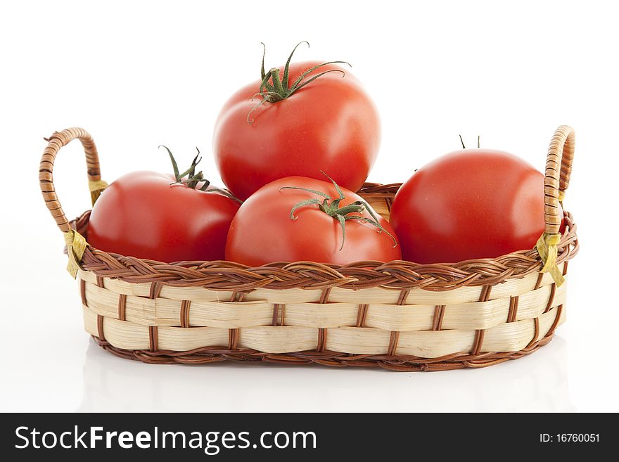 Ripe tomatoes in the woven basket