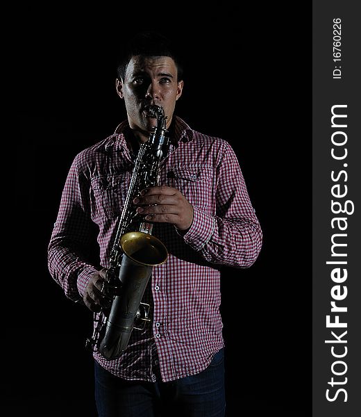 Young Handsome Man Playing Music On Saxophone