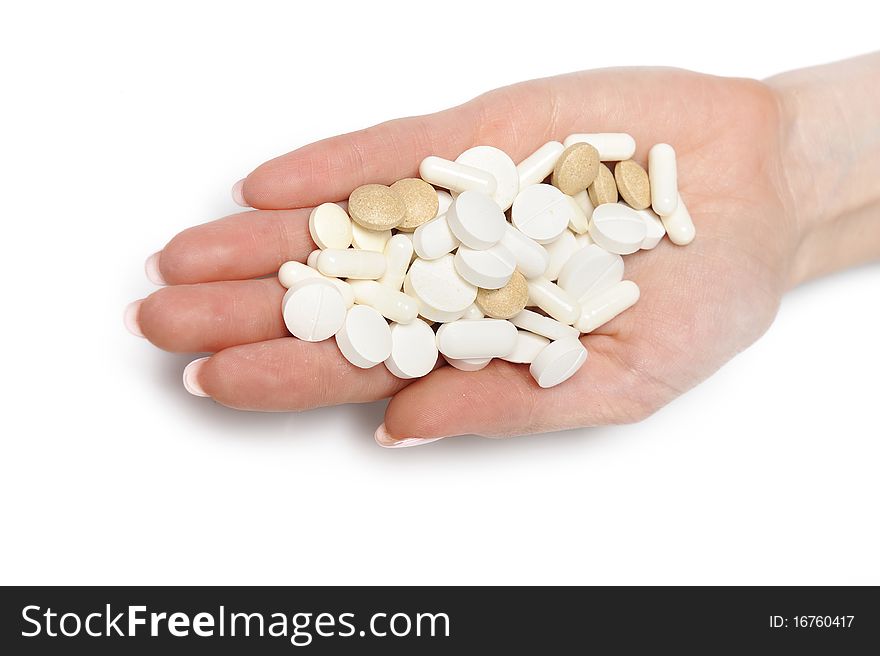 Beautiful woman hand with perfect manicure holding many medical pills. isolated on white background. Beautiful woman hand with perfect manicure holding many medical pills. isolated on white background