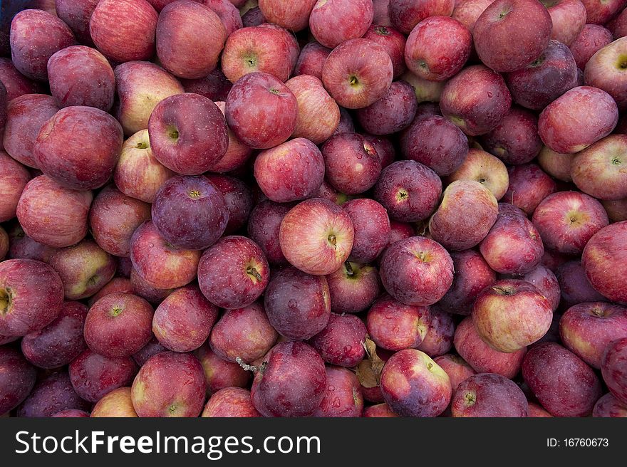 A pile of apples freshly picked at a farm stand can be used as a background