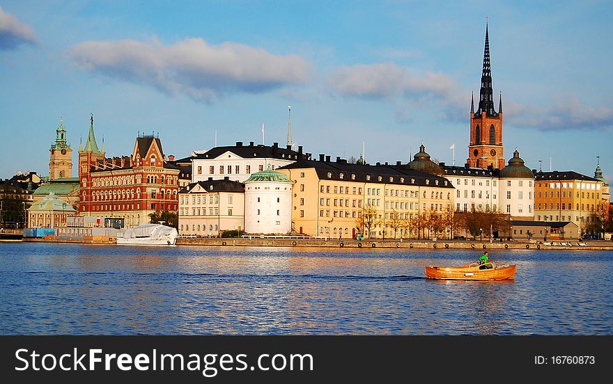 A distant view of the old city center of Stockholm..bright sunny day with a speed boat running through. A distant view of the old city center of Stockholm..bright sunny day with a speed boat running through...