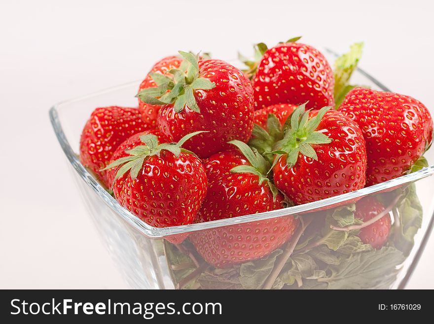 Strawberry with green leaf in the glass wase