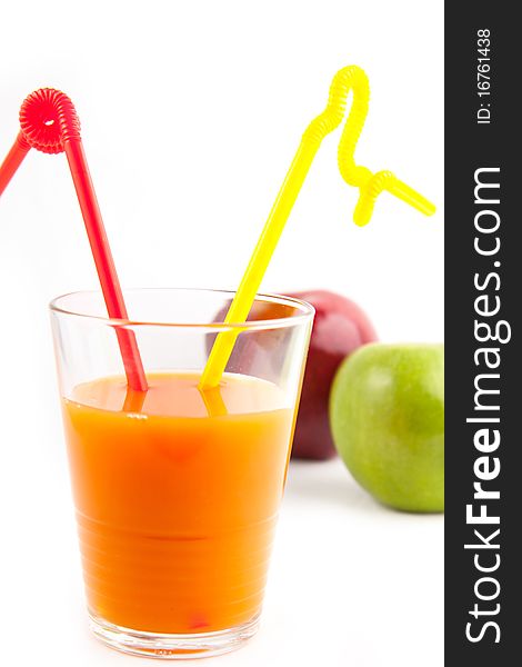 Orange juice in glass with two straw and tow apples. Orange juice in glass with two straw and tow apples