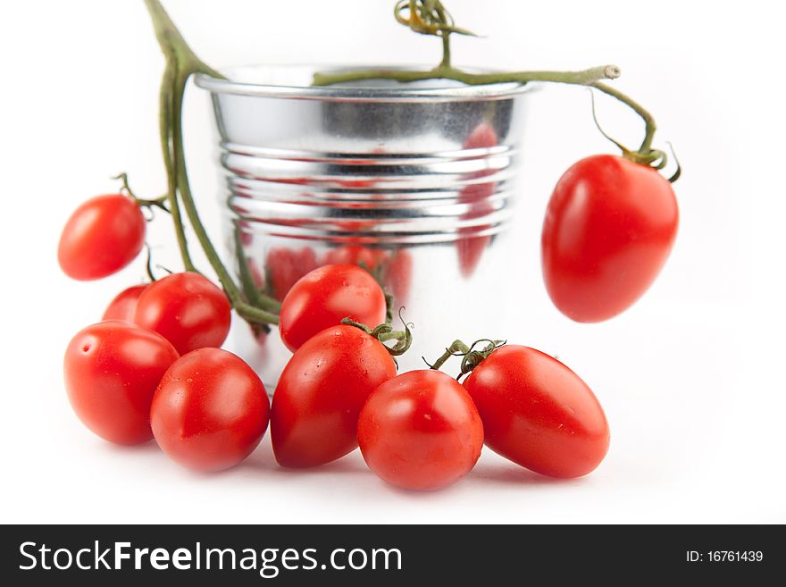 Branch of fresh cherry tomatoes on the white background