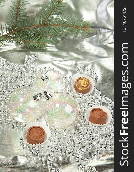 Transparent christmas balls with a homemade chocolate on a silver. Transparent christmas balls with a homemade chocolate on a silver