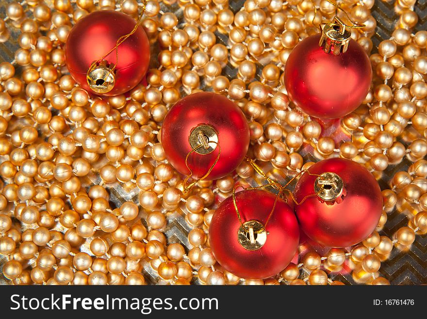 Red christmas balls on the golden beads