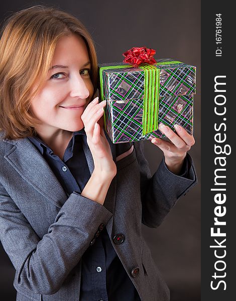 Girl in a business suit with a gift in a hands