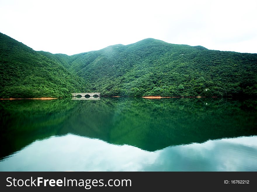 Spring landscape with mountain reflected in the lake. Spring landscape with mountain reflected in the lake