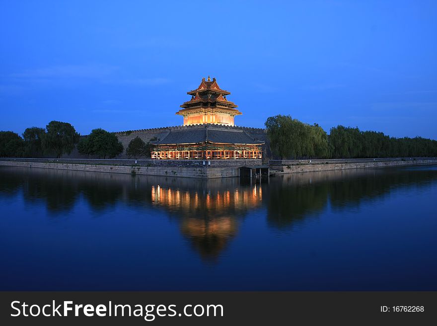 One of the turrets at the corner of Forbidden City in the dusk